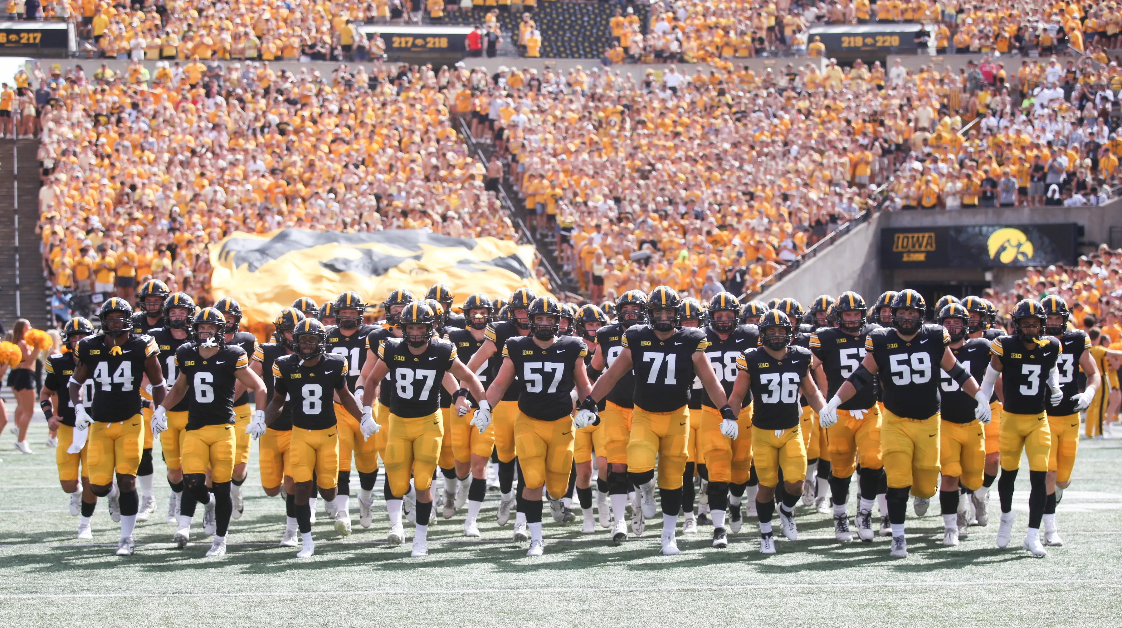 Fans watching college football game between Iowa and Iowa State