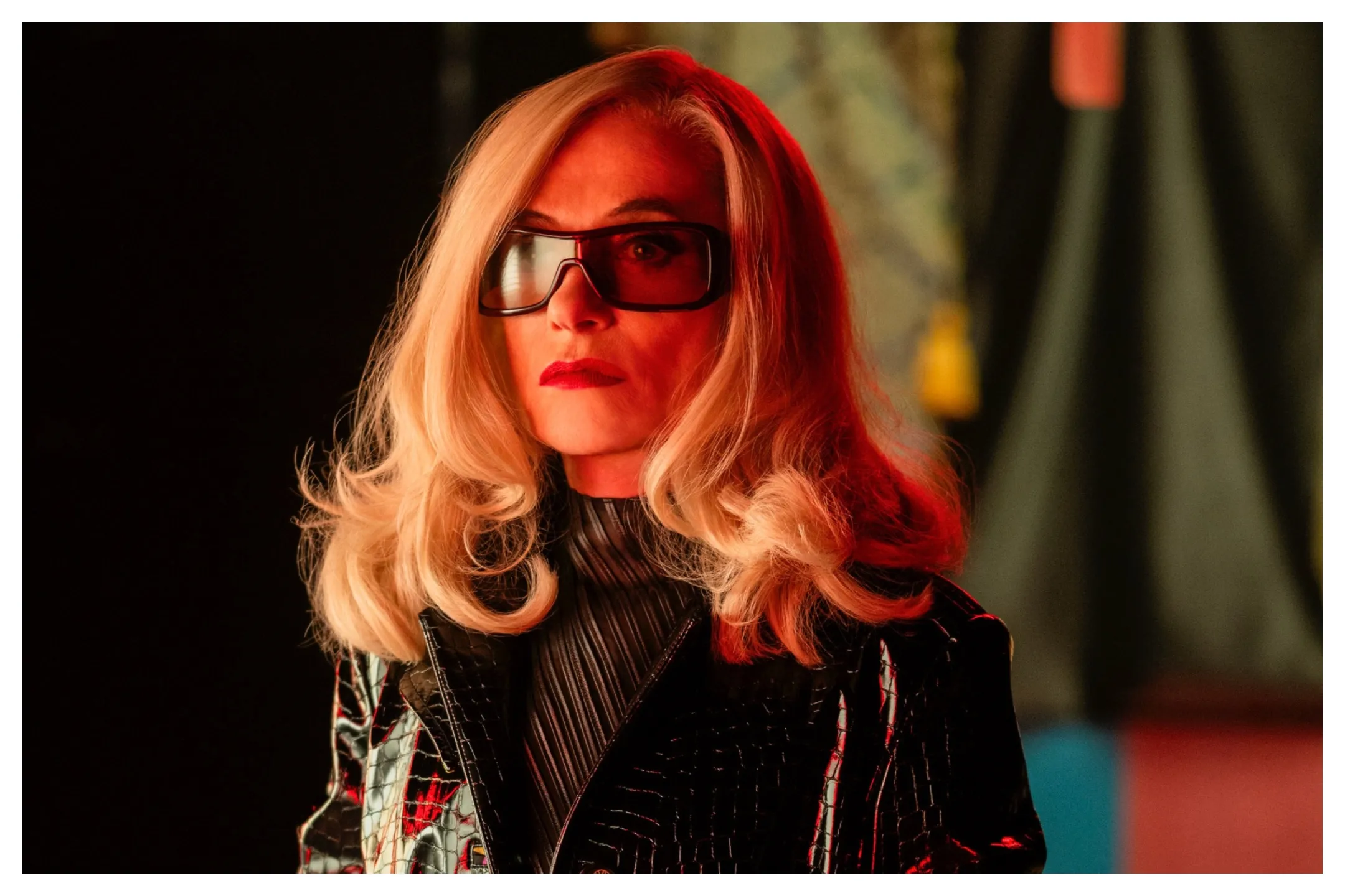 Isabelle Huppert in character as a crime boss