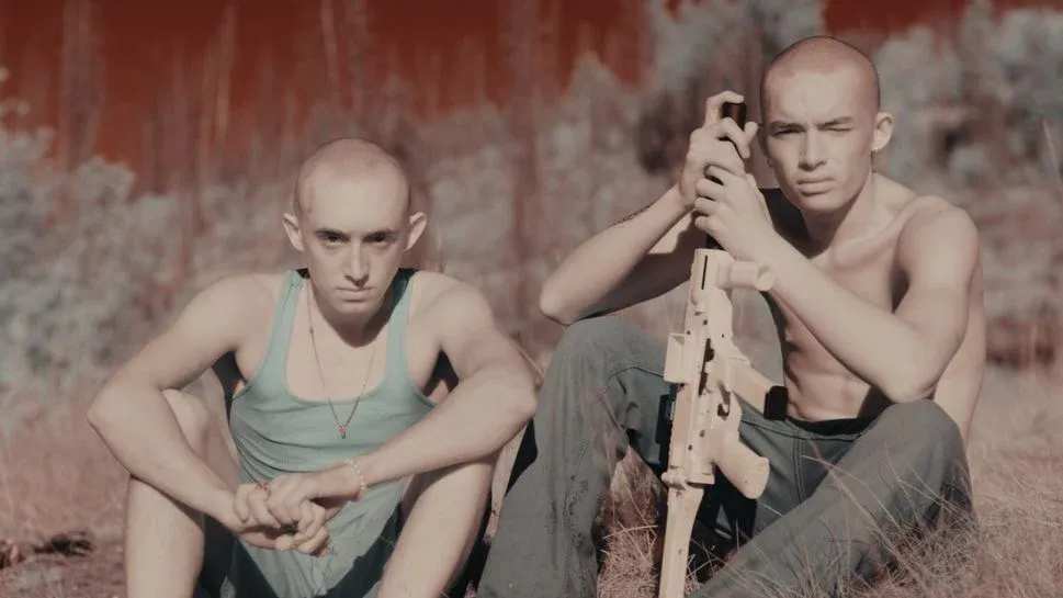 Still from ‘Manhunt’ featuring colorful visual elements