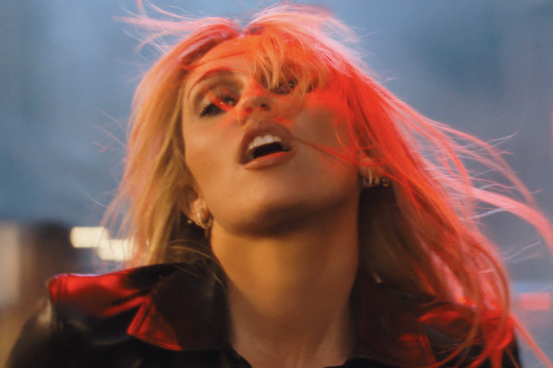 Miley Cyrus performing in a vibrant dance setting