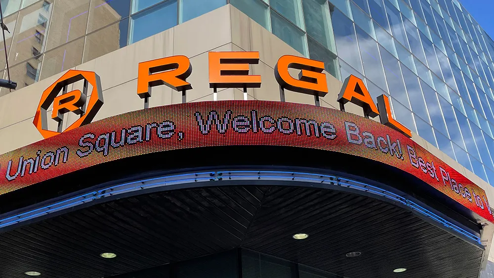Regal Cinemas logo with a movie theater background