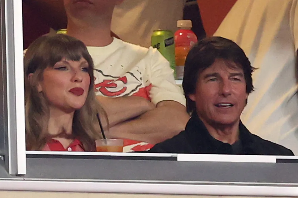 Tom Cruise Says Taylor Swift Was ‘Schooling Me on Football’ at Chiefs Game, Calls Her a ‘Brilliant Musician and Director’ news cover image